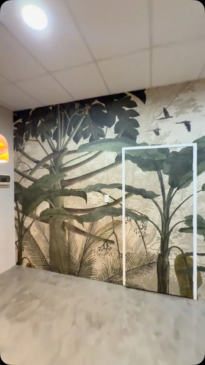 Botanical wallpaper mural covering a full-height wall