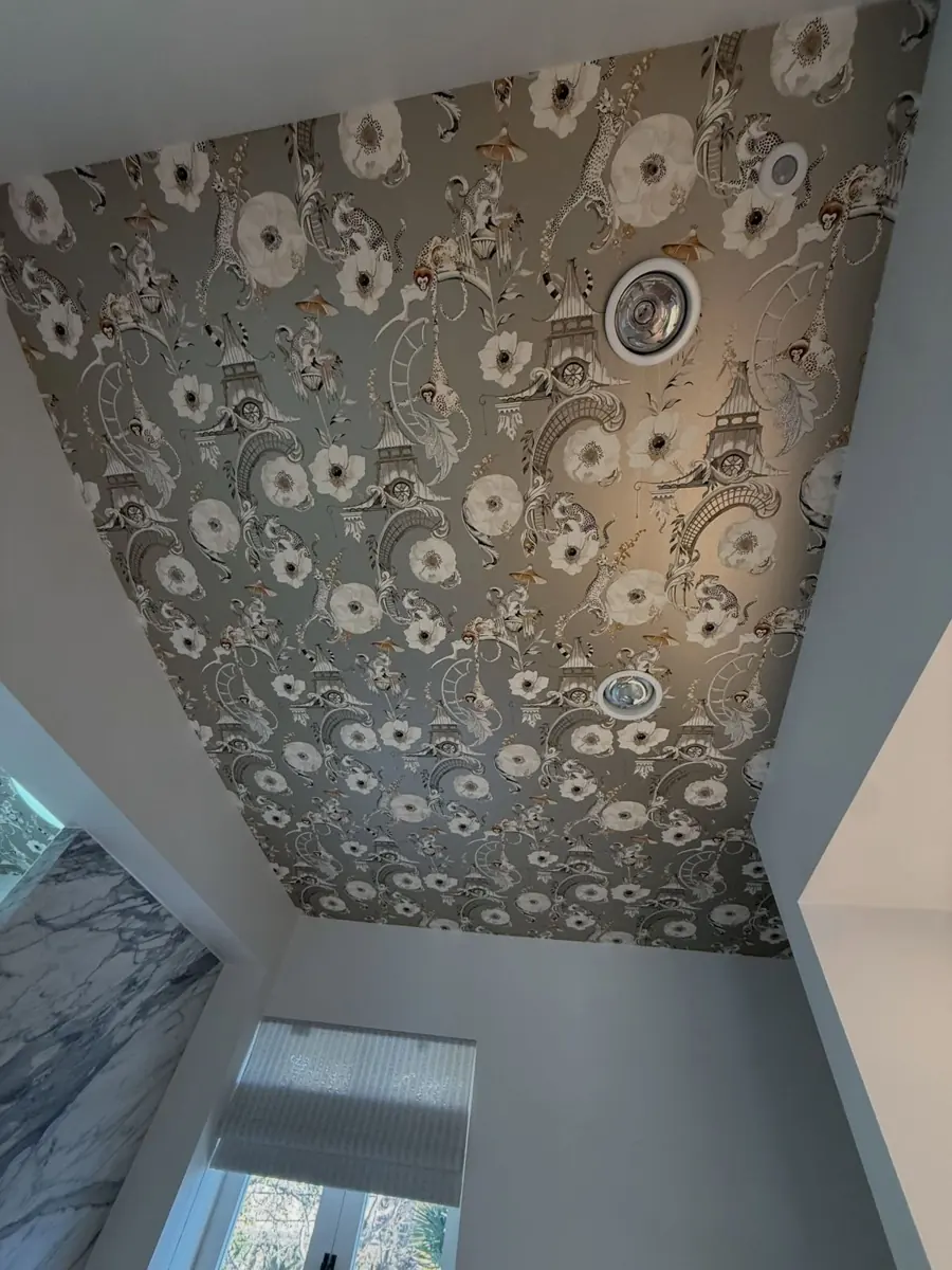 Floral wallpaper installed on a bathroom ceiling